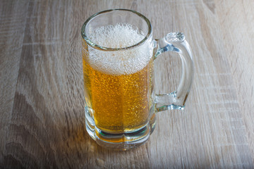glass of beer on a woody background