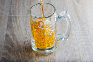 glass of beer on a woody background
