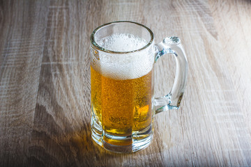 glass of beer on a woody background