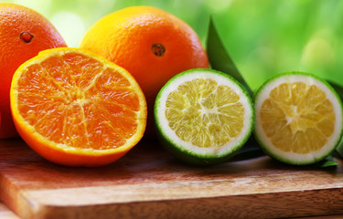 ripe and green oranges on table
