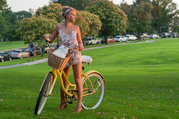 Happy young bicyclist riding in park.