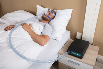 Man With Sleeping Apnea And CPAP Machine