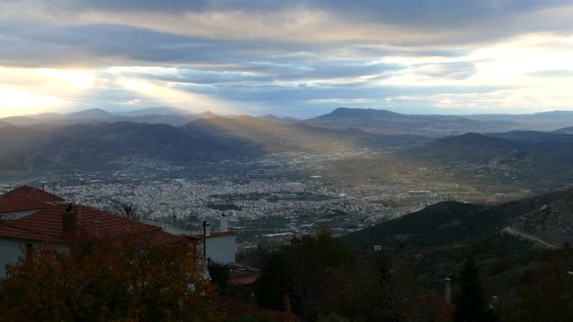 Sun shining over the city Volos in Greece