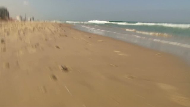 Slow motion running at beach POV