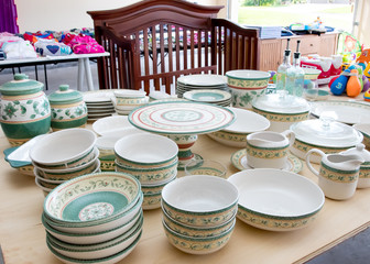 Tables of dishes and baby goods at a suburban garage sale