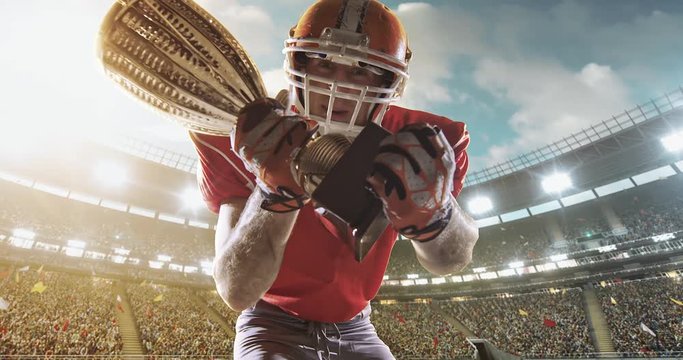 American football player happy with goblet 