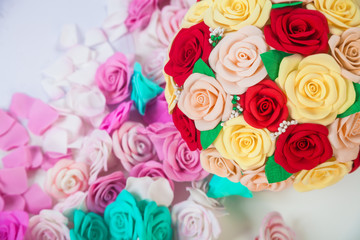Close-up of artificial flowers from the foyamir of various colors of red, yellow, beige, blue, pink, white in the slides for decorating weddings, interiors and holidays.