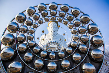 Circle and white buddha statue and blue sky