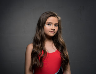 Fototapeta premium Teenaged pretty brunette against gray background