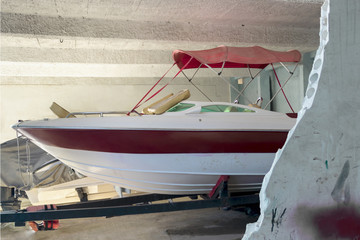 Boat parked in trailer inside marina. Indoors..