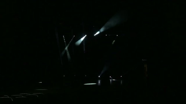 White stage lights. Several projectors in the dark. Stage lighting effect in the dark.