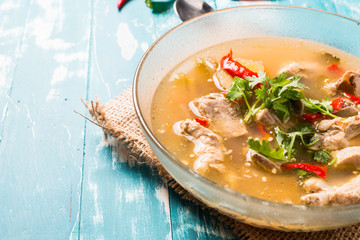 Hot and Spicy Soup with Pork Ribs on wooden background