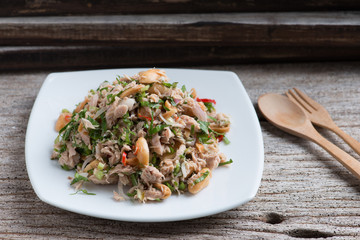 Spicy tuna salad on wood background