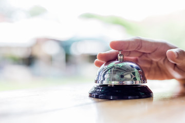 Service Bell. Person using their finger to ring a counter bell.