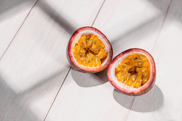 Half of passion fruit on wooden table.