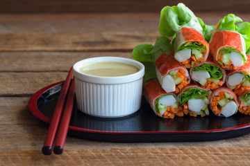 Fresh spring rolls with fresh vegetable and crab stick served with wasabi mixed salad cream dipping sauce. Rolls salad or fresh spring roll in Japanese style, healthy tasty food for appetizer or meal.