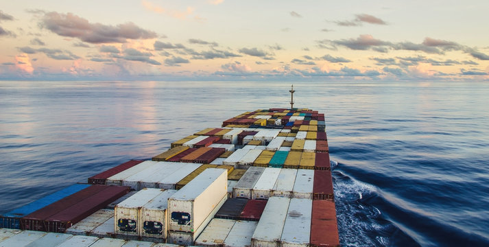 A container ship is going on the sunset