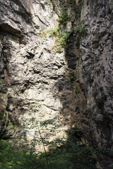 The rocky wall of the abyss with a small pond on the bottom.