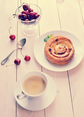 coffee in a mug, cupcake with cinnamon cherries