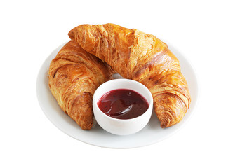 two Golden croissant with jam on the plate isolated