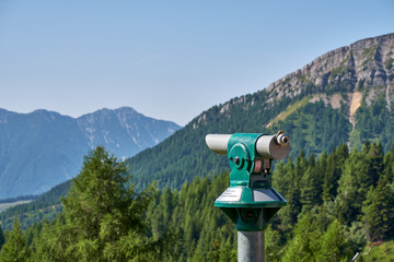 Free tourist telescope standing on the top of the Panoramastrasse on Mt. Goldeck the soft Staff peak in the background