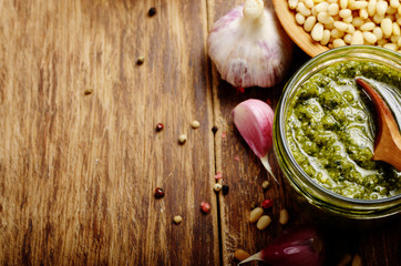 Top view of Pesto sauce and ingredients on wood table with copy-space