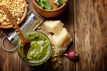 Top view of Pesto sauce ingredients and utensils on wood table