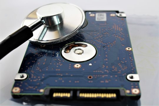 An concept image of a hard drive, disk and a stethoscope