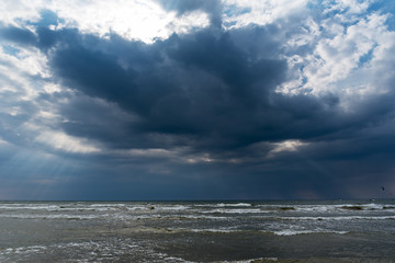 Kite surfers and dark Baltic sea.
