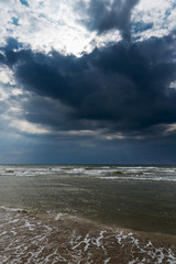 Kite surfers and dark Baltic sea.