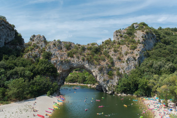 Fototapeta na wymiar Vallon-Pont-d'Arc in Ardeche, gorges, beautiful touristic landscape with kayaks on the river in France 