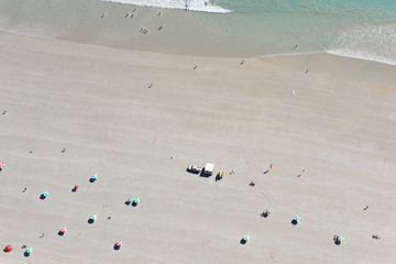 Looking down upon people enjoying the wide sands and waters of Cable Beach