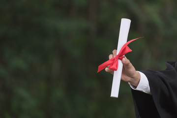 Student hands holding a degree certificate.on the campus.happiness in the university .learning,...