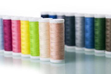 Sewing equipment and  threads on white background.