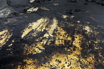 Oil spill texture on the sand beach