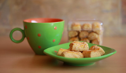 Kastengel or Dutch Indonesian cheese stick cookies and a cup of tea