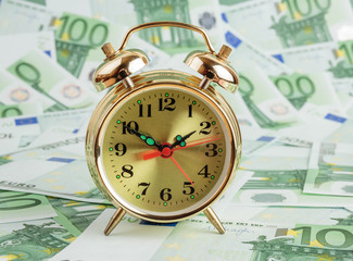 Alarm clock on a Euro banknotes