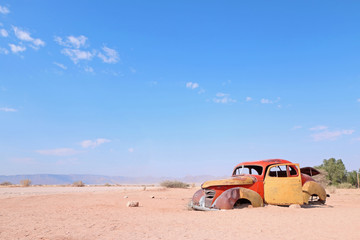 Rusty old car corroding in the desert in namibia