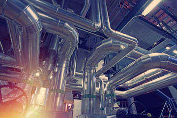 Equipment, cables and piping as found inside of a modern industrial power plant