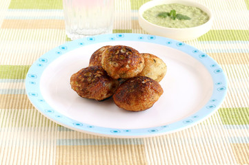 Paddu, south Indian vegetarian food, is usually made from a batter of lentils and rice.