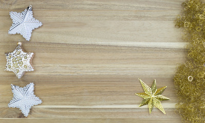 Beautiful white and gold christmas decoration on gold glitter and wood background.