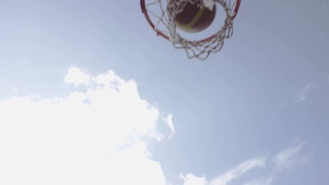 Male basketball player making a jump shot, in slow motion