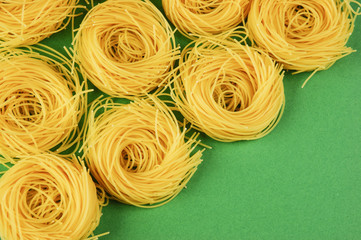 Tagliatelle pasta background on the green background