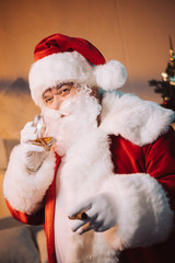 santa claus with glass of whiskey and cigar
