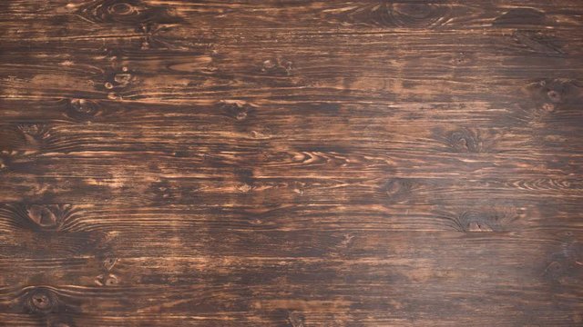 The fork and knife move on a wooden table time lapse