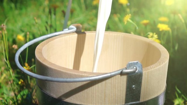  High quality video of pouring milk into wooden bucket in real 1080p slow motion 250fps