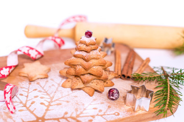 Homemade Gingerbread star shaped cookies Christmas Trees, decorated with berries, icing and sugar decorations.