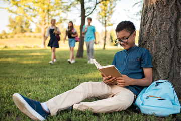 african american boy studying in park