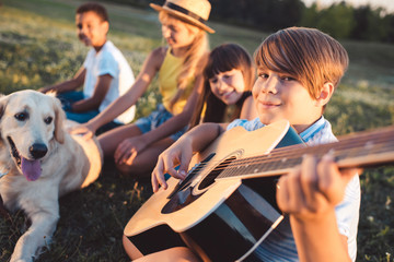 Fototapeta na wymiar multiethnic teenagers with guitar