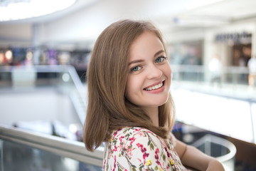 Portrait of young caucasian woman posing indoor, with soft background